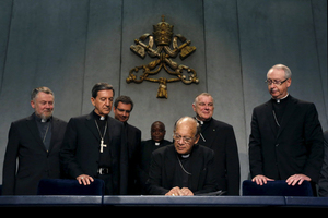 Cardinal Oswald Gracias (c.) signs an appeal next to Cardinal Ruben Salazar Gomez (2nd l.) during a news conference at the Vatican, Monday. Roman Catholic leaders from around the world on Monday made a joint appeal to a forthcoming United Nations conference on climate change to produce a 'fair, legally binding and truly transformational' agreement. Al­essandro Bianchi/Reuters